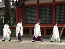 Priests walking in front of the shrine